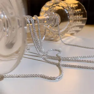 Elegant silver shimmer necklace with a sparkling wave-like texture, minimalist style