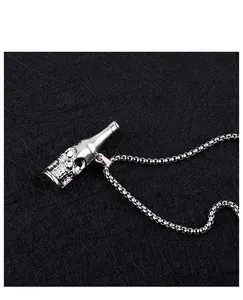 Macro detail shot of a silver skull beer bottle opener pendant necklace with box chain