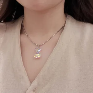 Close-up of a holographic acrylic bear pendant on a delicate silver ball chain necklace