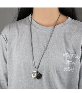 Detail view of a hip-hop style poker flush pendant necklace on a stainless steel chain.