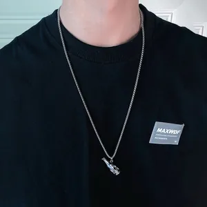 Close-up view of creative hip-hop skull beer bottle pendant necklace on black shirt