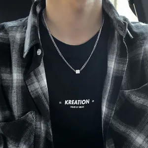 Minimalist titanium steel square pendant necklace worn by male model in streetwear style