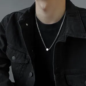 Detail view of a titanium steel hip-hop necklace with a minimalist geometric cube pendant.