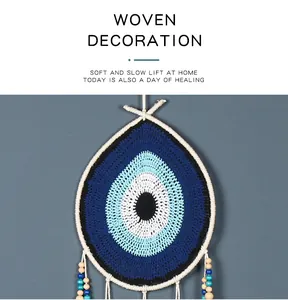 Macro detail of a handmade crochet Evil Eye dreamcatcher wall hanging ornament