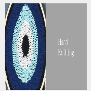 Macro view of hand-knitted bohemian evil eye dreamcatcher wall hanging decoration