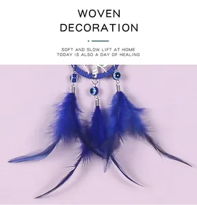 Détail en gros plan des plumes et perles bleues d'un attrape-rêves Evil Eye