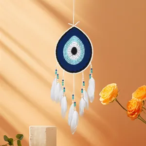 Handmade bohemian evil eye dreamcatcher with white feathers and blue crochet design