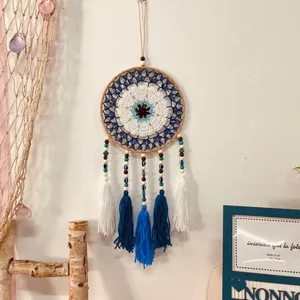 Handmade Bohemian Evil Eye dreamcatcher with crochet pattern and tassels for home decor