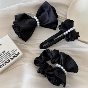 Elegant set of black satin bow hair clips and scrunchie with white pearl details