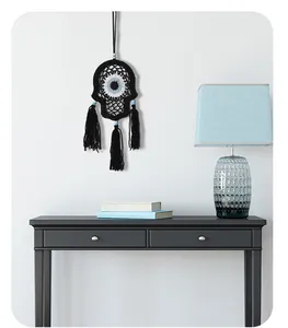 Handmade Hamsa Evil Eye macrame wall hanging decoration shown in a modern interior.