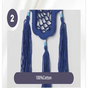 Detailed view of the handcrafted blue cotton tassels and beads on Evil Eye wall hanging