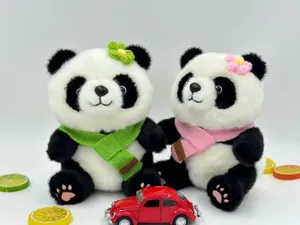 Pair of cute panda plush toys featuring pink and green knitted scarves and flower pins
