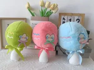 Detail of three colorful plush lollipop hammer toys in green, pink, and blue