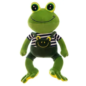 Detailed close-up of a cute green frog plush toy wearing a striped shirt and overalls