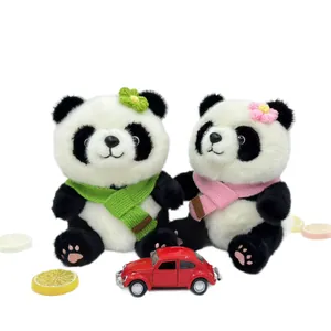 Pair of cute plush panda toys wearing colorful knit scarves and flowers
