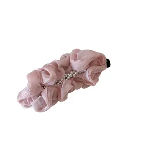 Elegant pink pleated fabric hair clip with pearl accents for women's ponytail hairstyles