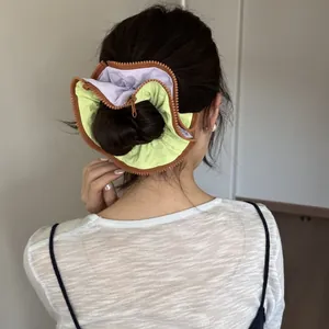 Large Korean style zipper scrunchie in purple and green for bun hair styling.