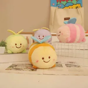 Cute assortment of colorful plush bee toys with happy faces displayed on a cozy desk setup