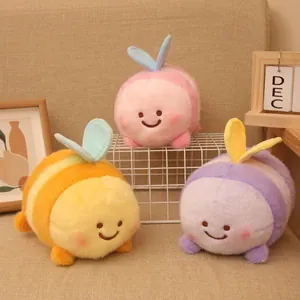 Detailed view of three colorful bee plush toys with cute embroidered smiling faces
