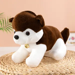 Close-up of a cute husky plush toy with a golden bell sitting on a woven mat
