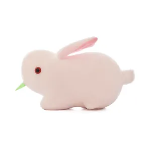 Detailed side view of a soft pink plush rabbit toy featuring red eyes and long ears.