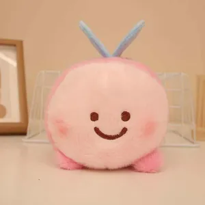 Close-up detail of a cute pink plush bee toy with soft faux fur and light blue wings