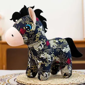 Full side view of a Chinese style zodiac horse plush toy with traditional floral patterns on a mat