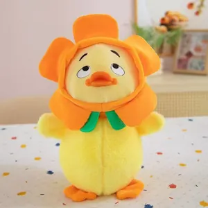 Close-up of cute yellow duck plush toy wearing an orange flower hat and green bow tie