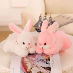 Detailed view of cute white and pink rabbit plush toys with stylish polka dot ribbons
