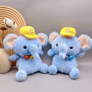 Close-up detail of two adorable blue elephant plush toys wearing yellow hats and bells