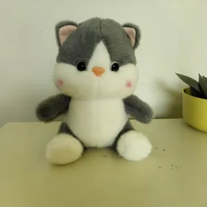 Close-up of a cute gray and white plush cat toy with big eyes and soft fluffy texture