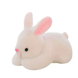 Detailed view of a soft white plush bunny toy with pink ears and polka dot ribbon