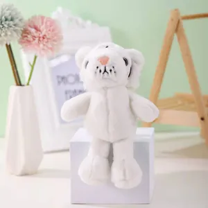 Front view of a cute mini white tiger plush keychain sitting on a white display block