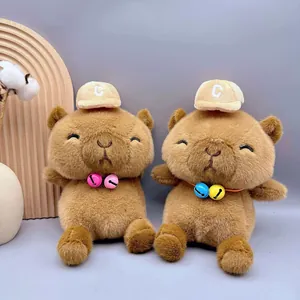 Close-up detail of cute capybara plush toys with bells and mini hats