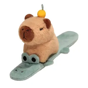 Close-up detail of a cute capybara plush toy on a crocodile-shaped slap bracelet strap