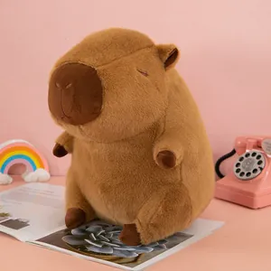 Detailed view of a soft brown capybara plush toy sitting elegantly on a pink background