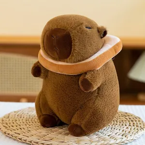Detailed view of a soft brown capybara plush toy wearing a cute decorative bread collar