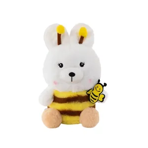 Adorable white plush bear toy in a yellow bee costume with stripes and a tiny bee