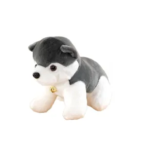 Adorable plush husky dog toy featuring a small golden bell on a clean white background