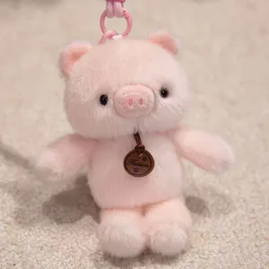 Adorable pink plush pig keychain with a very soft texture and a stylish fashion tag.