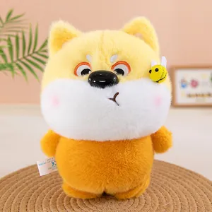 Close-up of adorable orange and white plush dog toy with a small bee accessory on its head