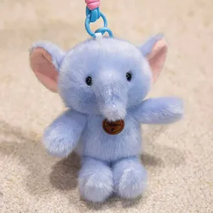 Close-up of a soft blue elephant plush keychain with pink ears and cute trunk