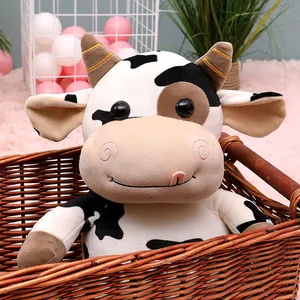 Cute black and white spotted cow plush toy sitting in a woven basket gift for kids.