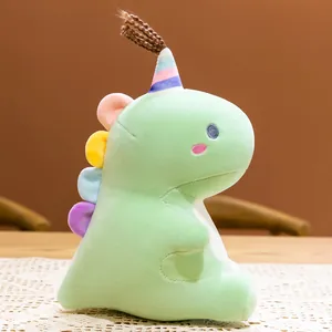 Lindo peluche de dinosaurio verde suave con gorro de cumpleaños colorido para los niños.