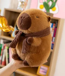 Detailed view of a soft brown capybara plush toy wearing a cozy knitted scarf.