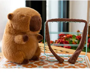 Close-up of a soft brown plush capybara toy with its matching knitted scarf accessory