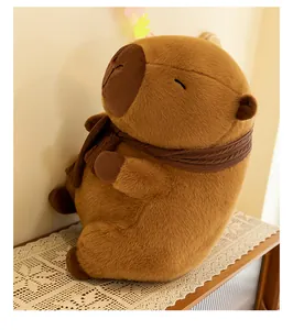 Detailed side view of a cozy brown capybara plush toy wearing a warm knit scarf on a table