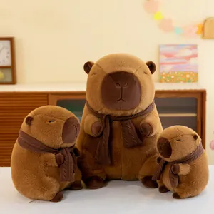 Three cute Capybara plush dolls in various sizes wearing cozy brown knitted scarves