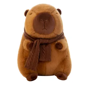 Adorable brown capybara plush toy wearing a cozy knitted scarf on a clean white background.
