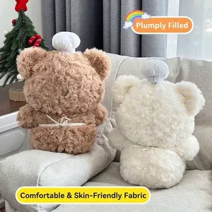 Back view of cute brown and white plush bears wearing chef hats on a cozy sofa